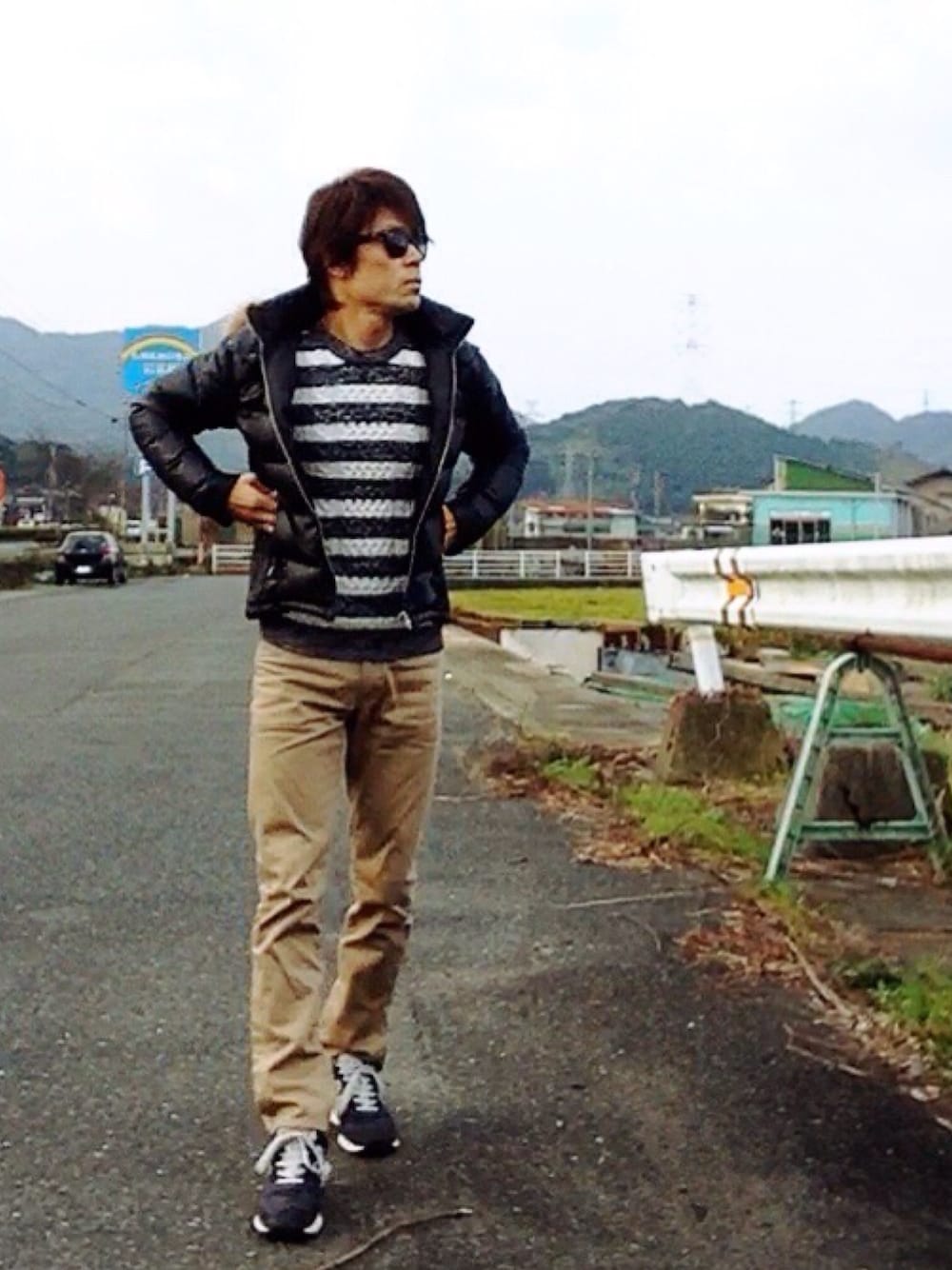 ベージュ系のチノパンツ、ブルー系のスニーカー、ホワイト系のニット/セーターを着用したメンズの冬コーディネートの1枚目の写真