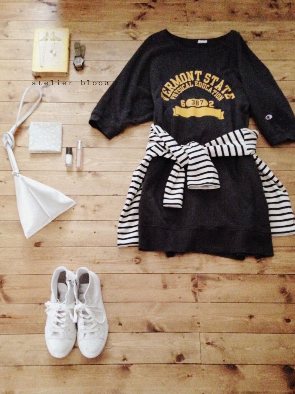 ホワイト系のTシャツ/カットソー、ホワイト系のクラッチバッグ、ゴールド系のネックレスを着用したレディースの春コーディネートの1枚目の写真