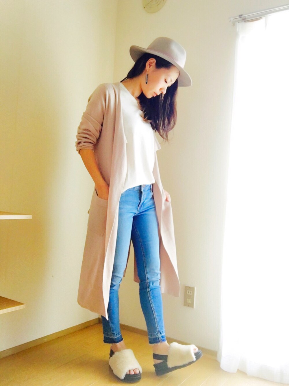 ホワイト系のTシャツ/カットソー、ベージュ系のカーディガン/ボレロ、ブルー系のデニムパンツを着用したレディースの秋コーディネートの1枚目の写真