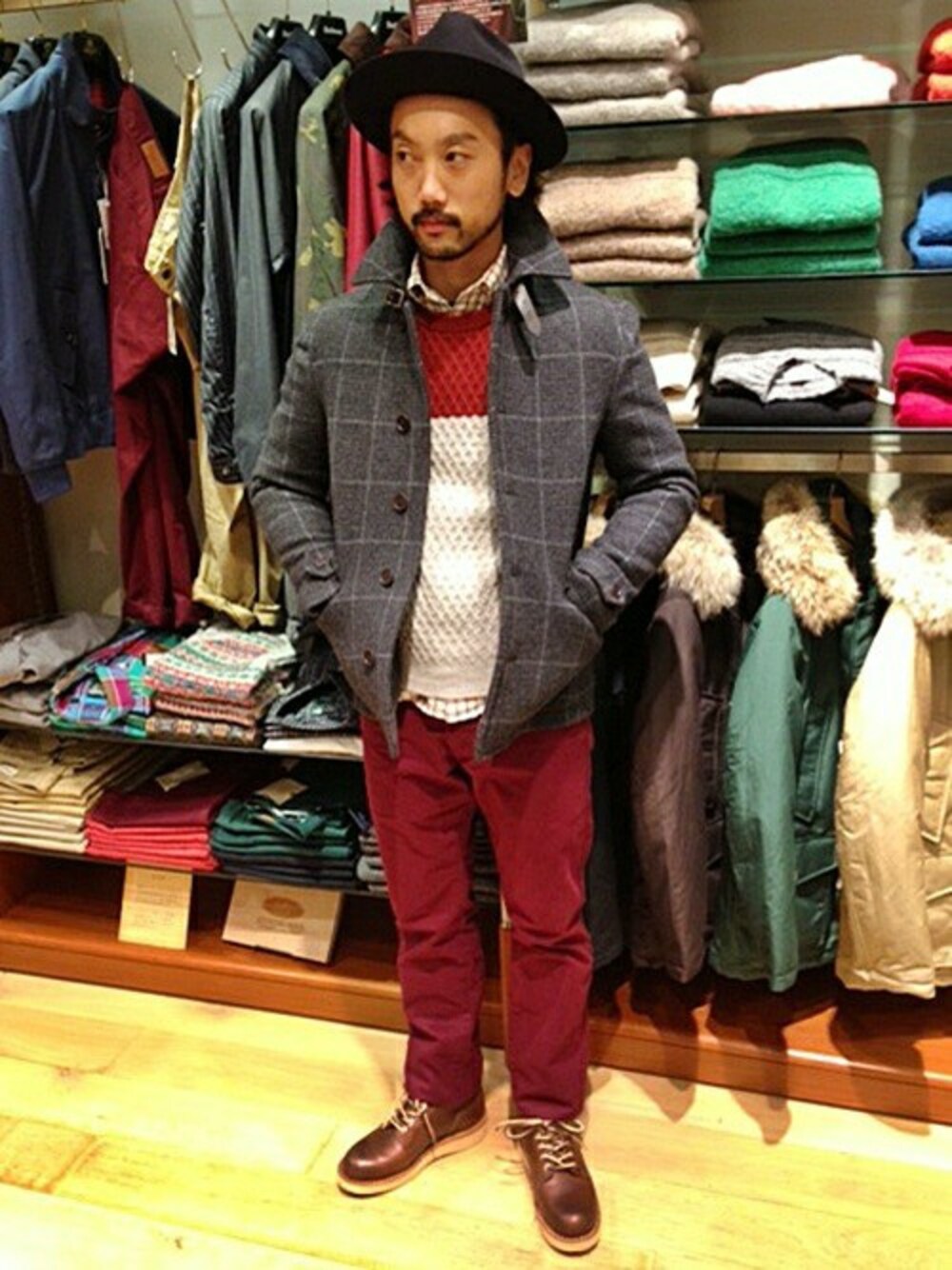 グレー系のピーコート、レッド系のチノパンツ、レッド系のニット/セーターを着用したメンズの秋コーディネートの1枚目の写真