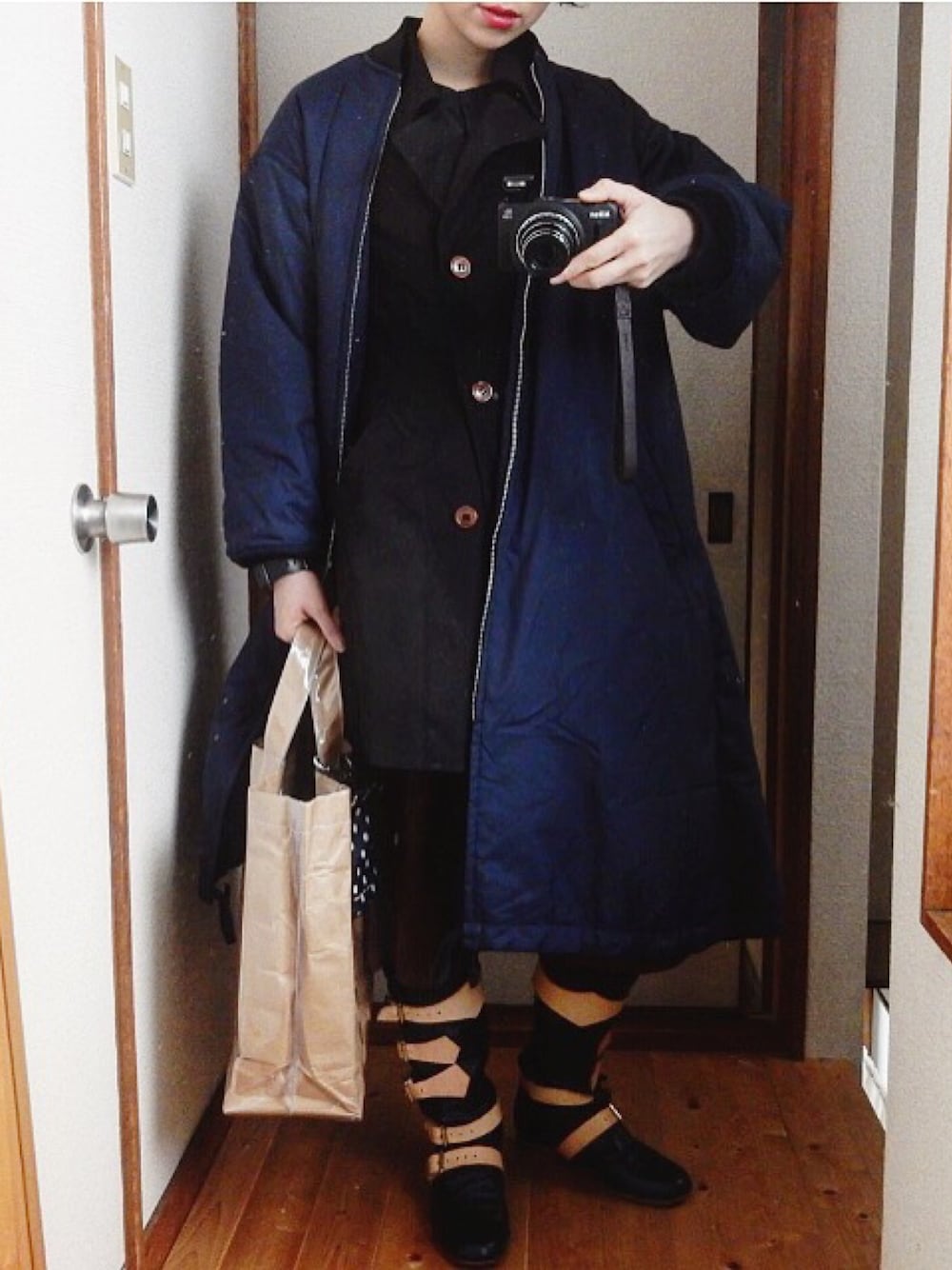 ブルー系のその他アウター、ブラック系のブーツ、ベージュ系のトートバッグを着用したレディースの冬コーディネートの1枚目の写真