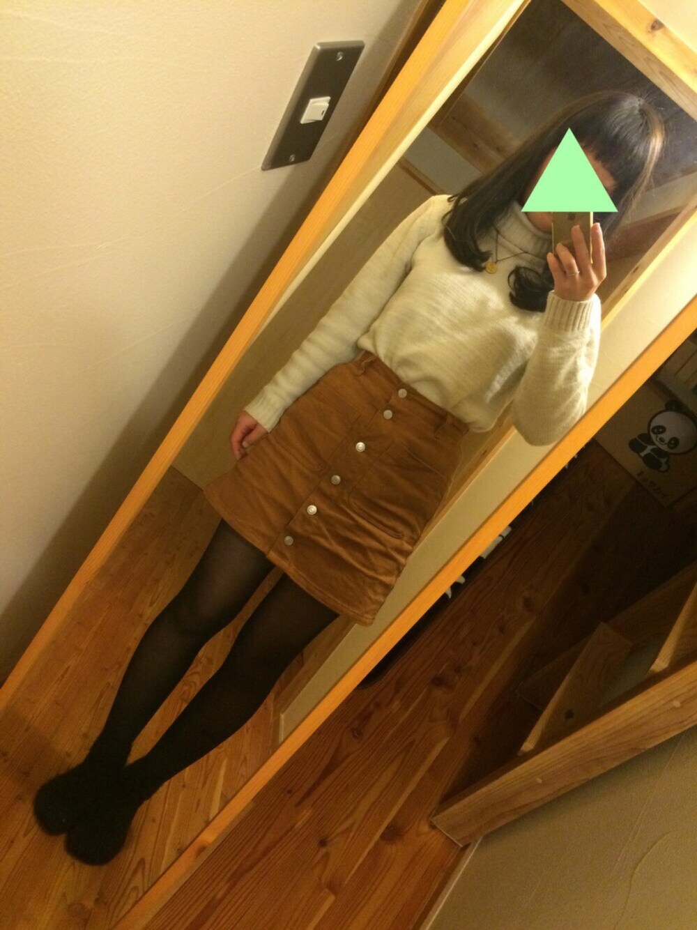 ベージュ系のニット/セーター、ブラウン系のスカート、ブラック系のソックス/靴下を着用したレディースの冬コーディネートの1枚目の写真