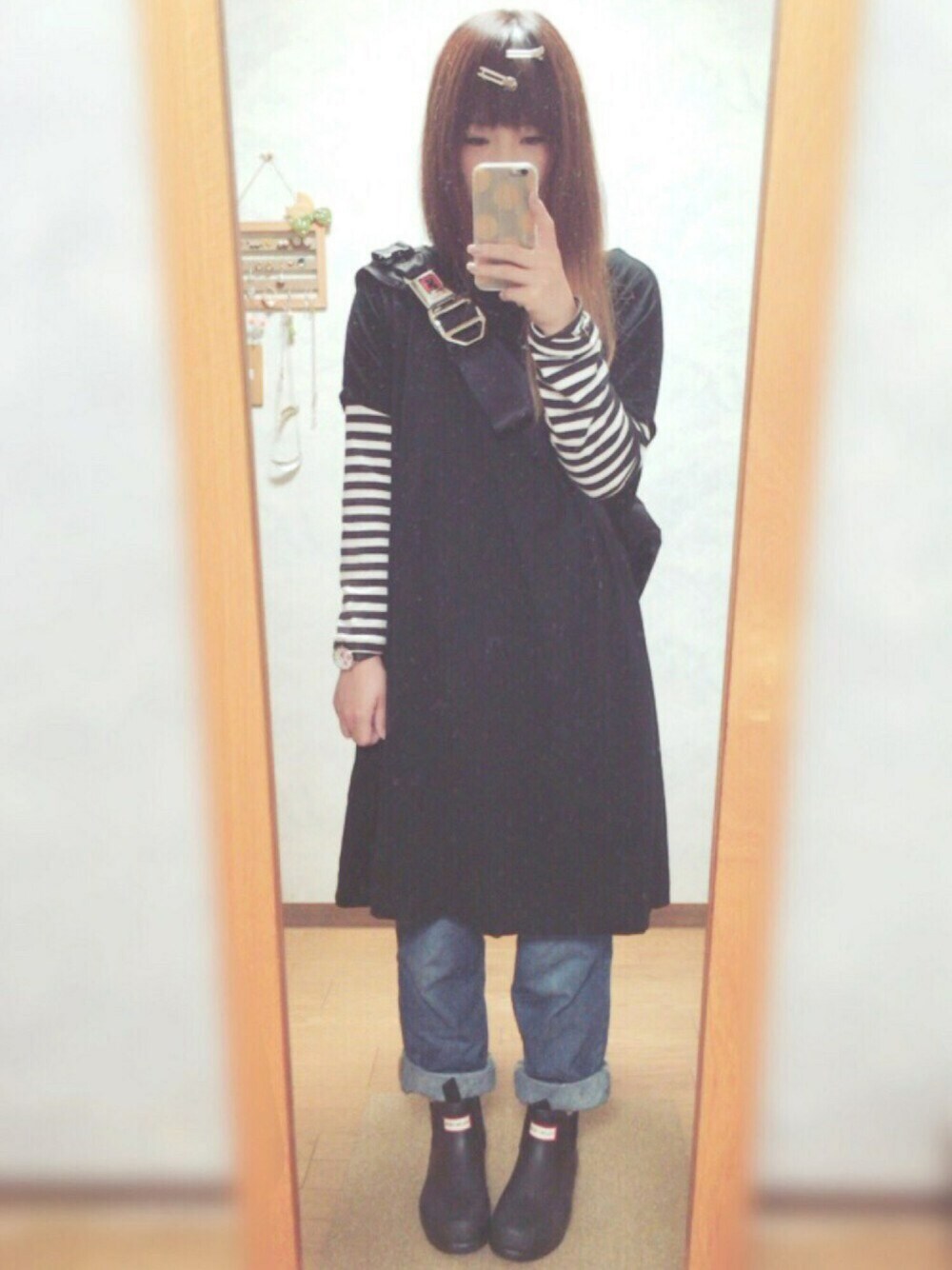 ブラック系のレインシューズ、ブルー系のデニムパンツ、ブラック系のTシャツ/カットソーを着用したレディースの秋コーディネートの1枚目の写真