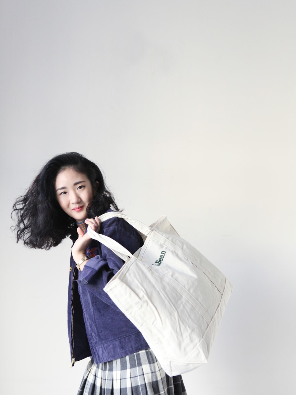 ホワイト系のショルダーバッグ、ブルー系のその他アウターを着用したレディースの冬コーディネートの1枚目の写真