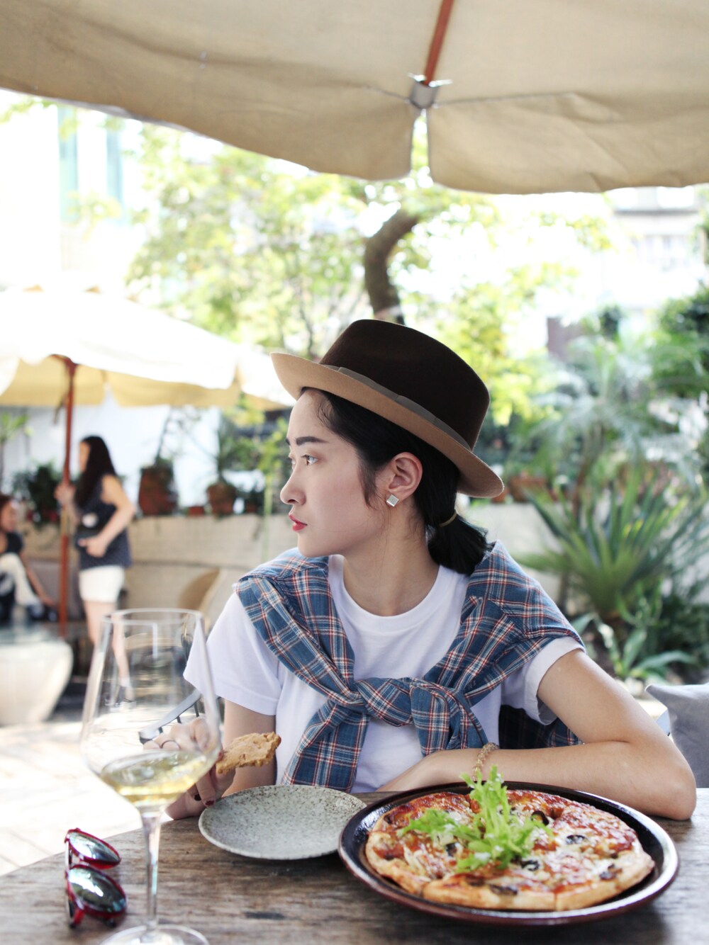 ブラウン系のハットを着用したレディースの春コーディネートの1枚目の写真