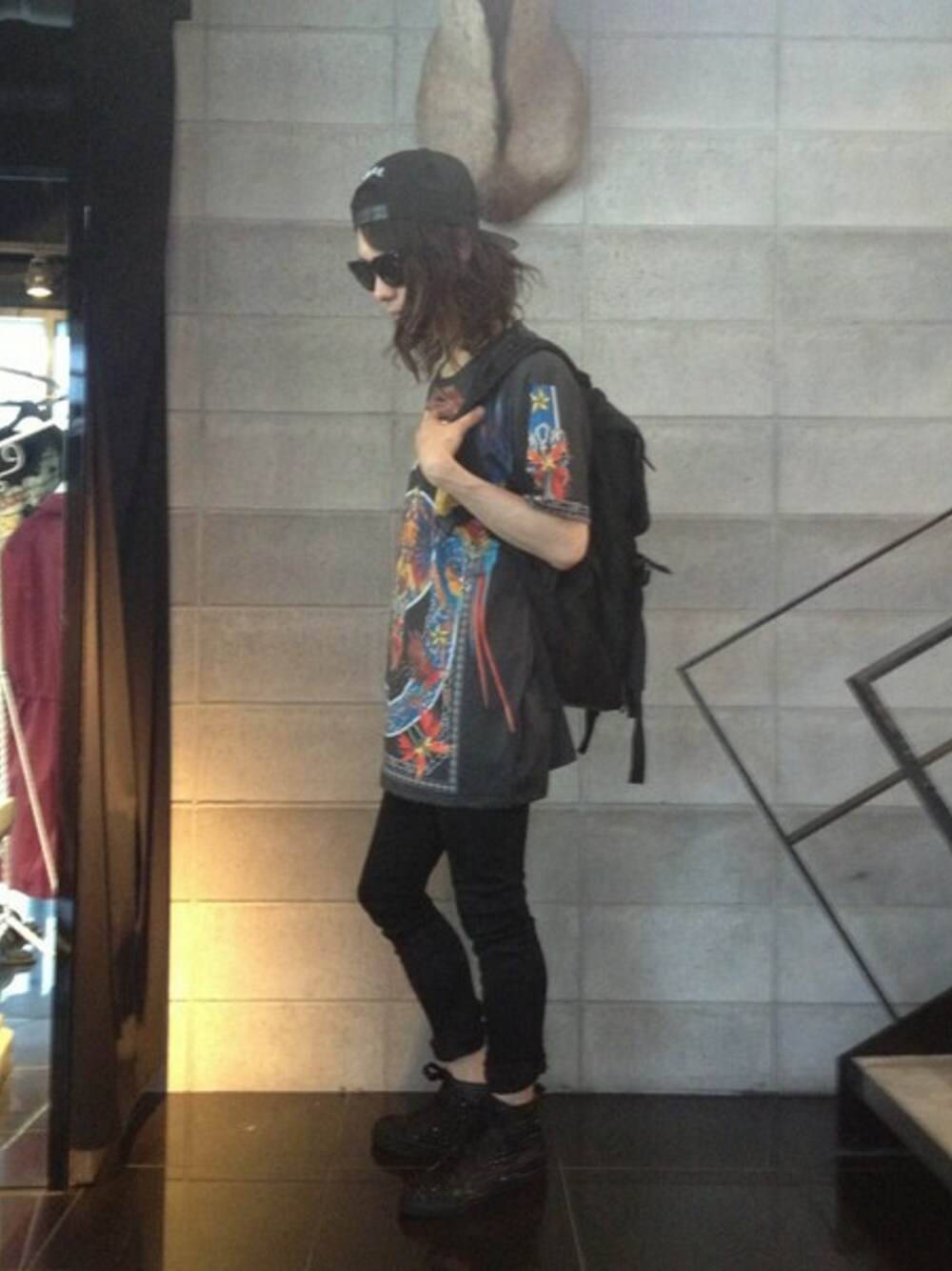 ブラック系のTシャツ/カットソー、ブラック系のスニーカー、ブラック系のバックパック/リュックを着用したメンズの春コーディネートの1枚目の写真