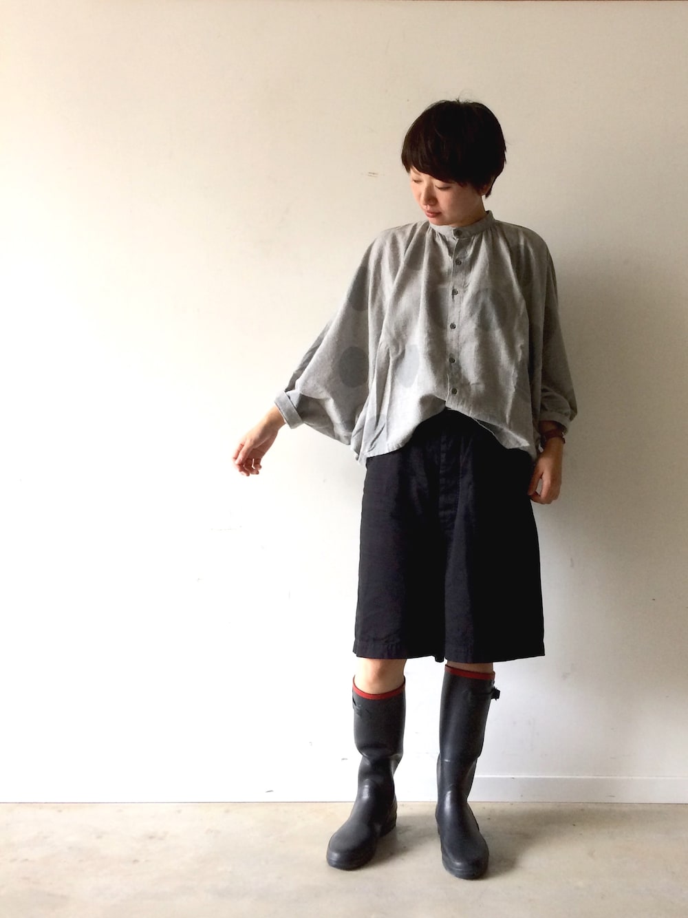 ブラック系のレインシューズ、ブルー系のシャツ/ブラウス、ブラック系のパンツを着用したレディースの秋コーディネートの1枚目の写真