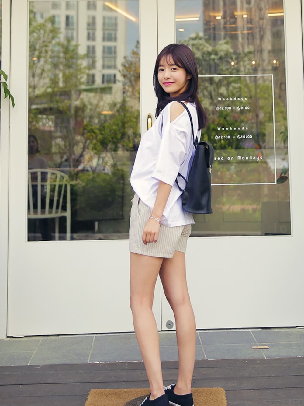 ホワイト系のTシャツ/カットソー、ブラック系のスニーカーを着用したレディースの春コーディネートの1枚目の写真