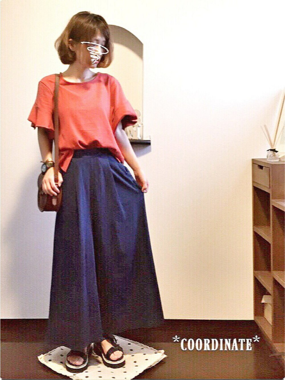 オレンジ系のTシャツ/カットソー、ブルー系のパンツ、ブラック系のサンダルを着用したレディースの夏コーディネートの1枚目の写真