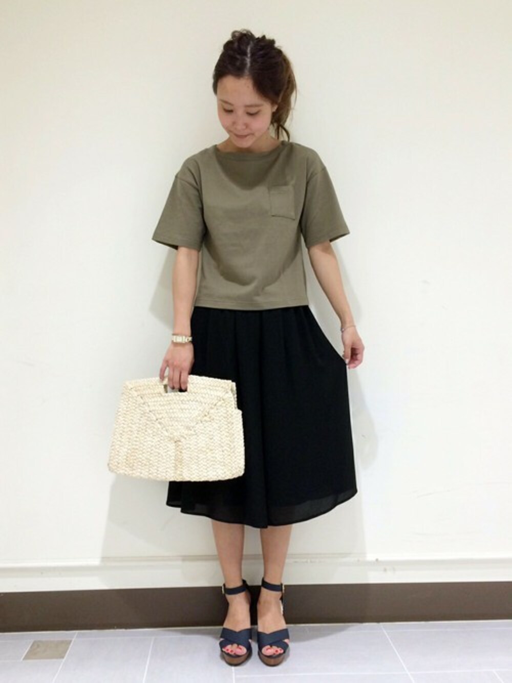 ベージュ系のクラッチバッグ、ブルー系のサンダル、ブラック系のその他パンツを着用したレディースの春コーディネートの1枚目の写真