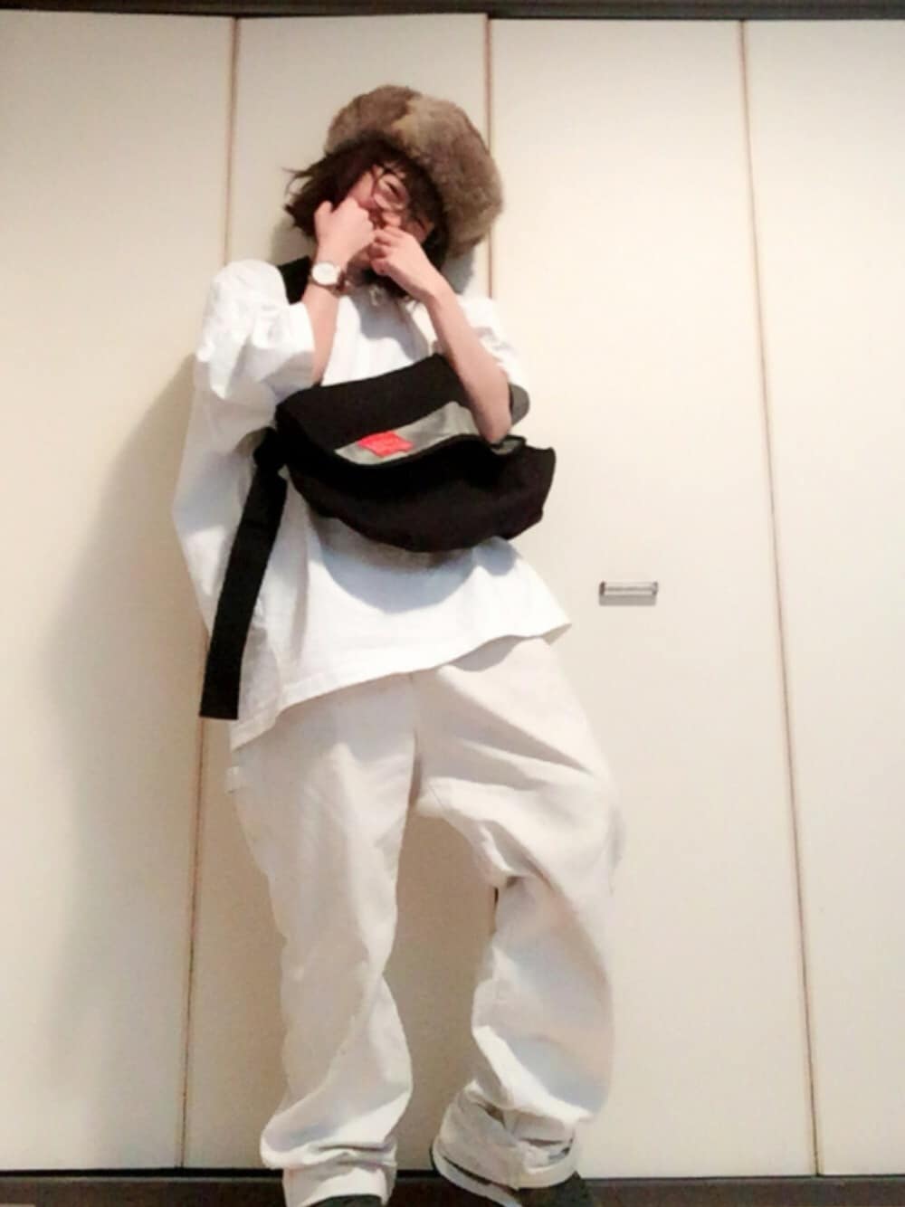 ホワイト系のTシャツ/カットソー、ブラック系のショルダーバッグ、ホワイト系のデニムパンツを着用したレディースの冬コーディネートの1枚目の写真