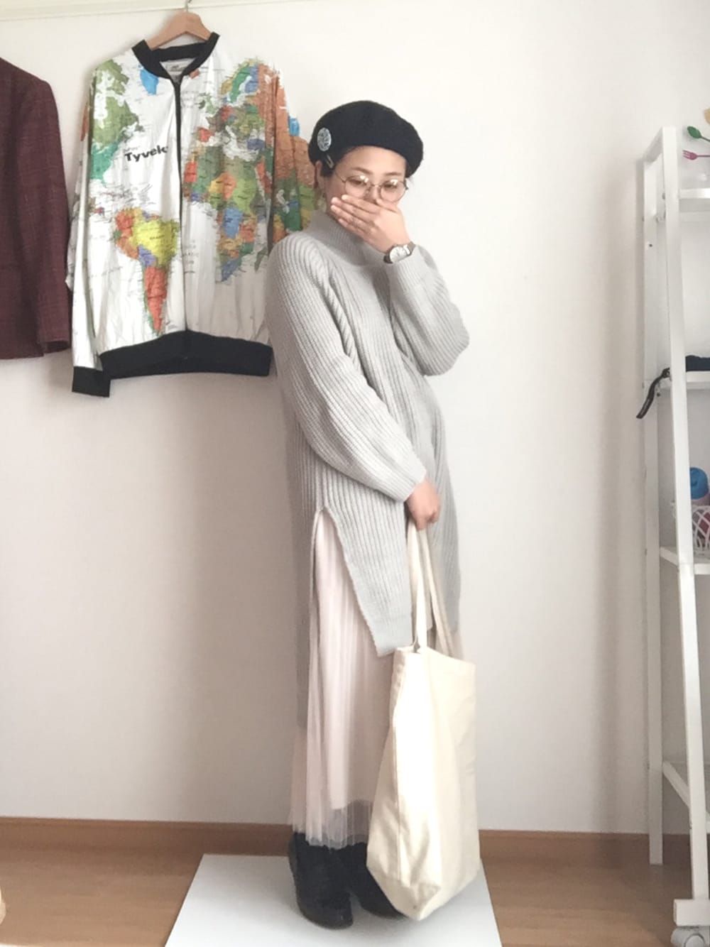 グレー系のワンピース、ベージュ系のスカート、ベージュ系のエコバッグ/サブバッグを着用したレディースの冬コーディネートの1枚目の写真