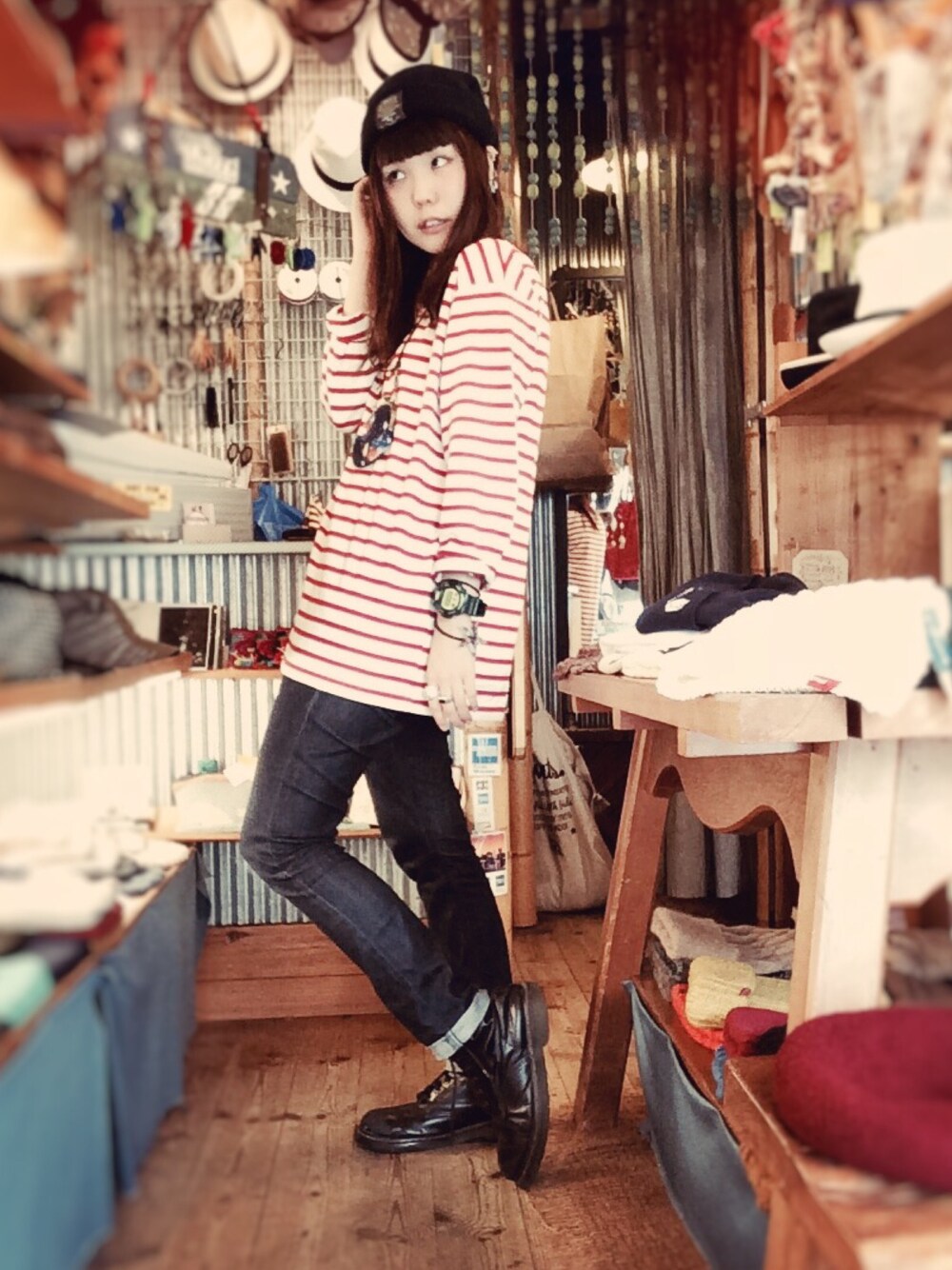 ブラック系のブーツ、ブルー系のデニムパンツ、レッド系のTシャツ/カットソーを着用したレディースの秋コーディネートの1枚目の写真