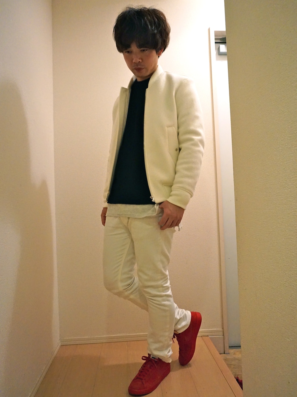 ホワイト系のブルゾン、ブラック系のニット/セーター、ホワイト系のTシャツ/カットソーを着用したメンズの冬コーディネートの1枚目の写真