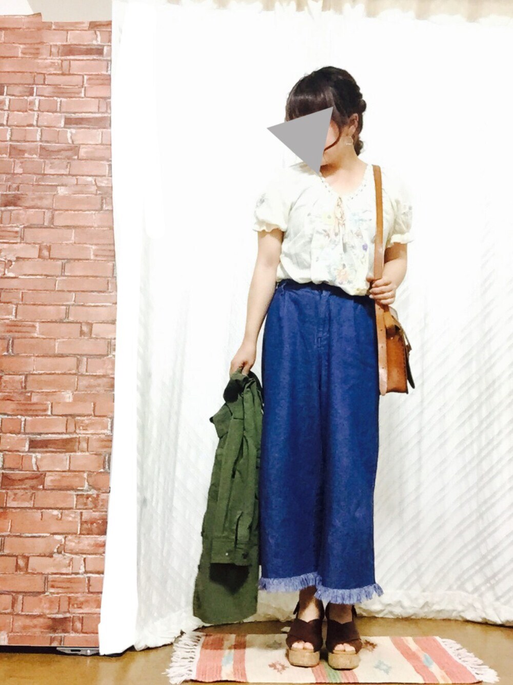 グリーン系のミリタリージャケット、オレンジ系のTシャツ/カットソー、ブルー系のその他パンツを着用したレディースの春コーディネートの1枚目の写真