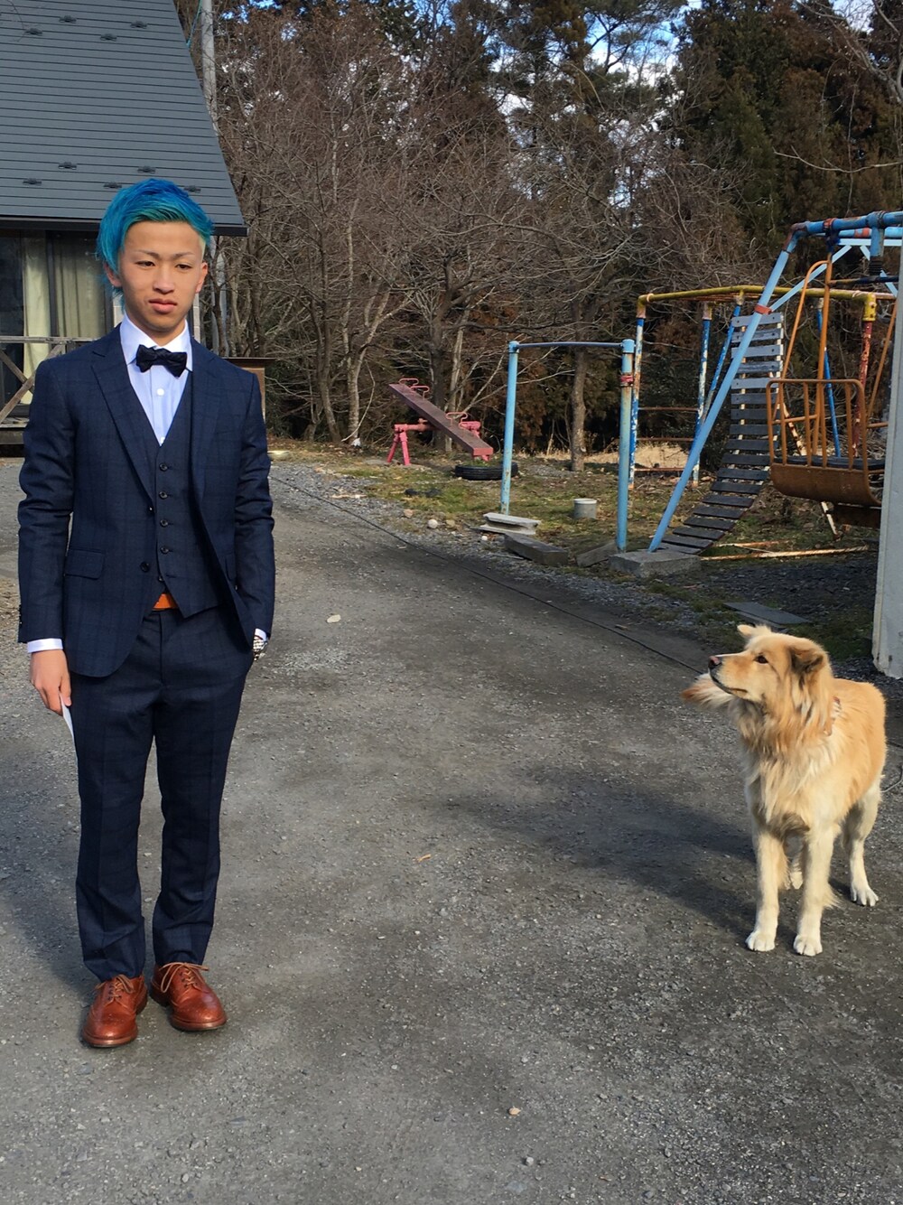 ブラウン系のブーツ、ブルー系のスーツジャケット、シルバー系のアナログ腕時計を着用したメンズの冬コーディネートの1枚目の写真