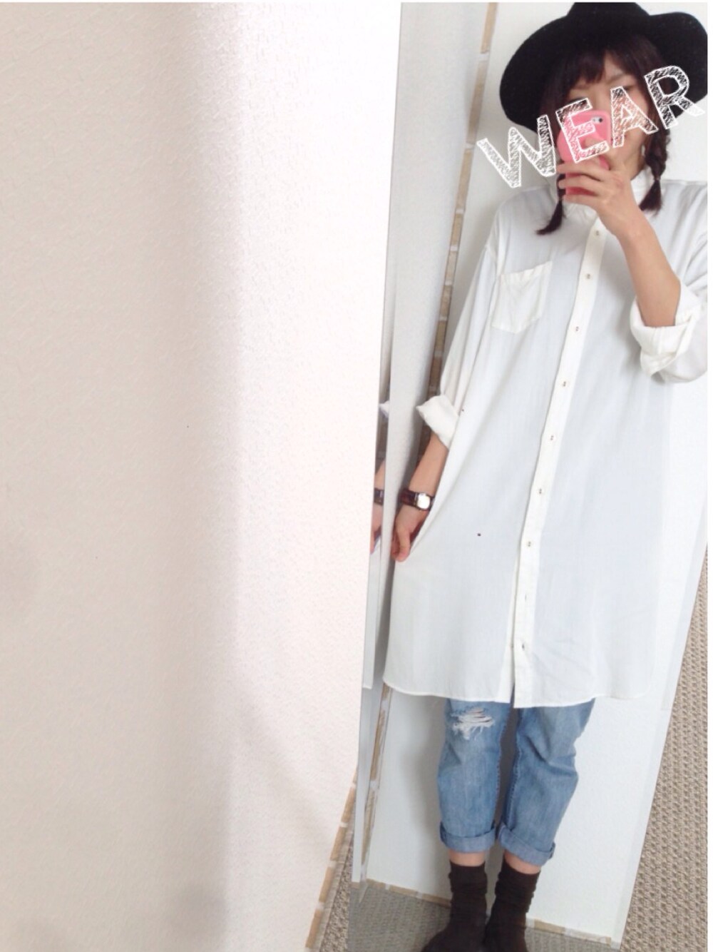 ブルー系のデニムパンツ、ホワイト系のシャツワンピース、ブラック系のハットを着用したレディースの秋コーディネートの1枚目の写真