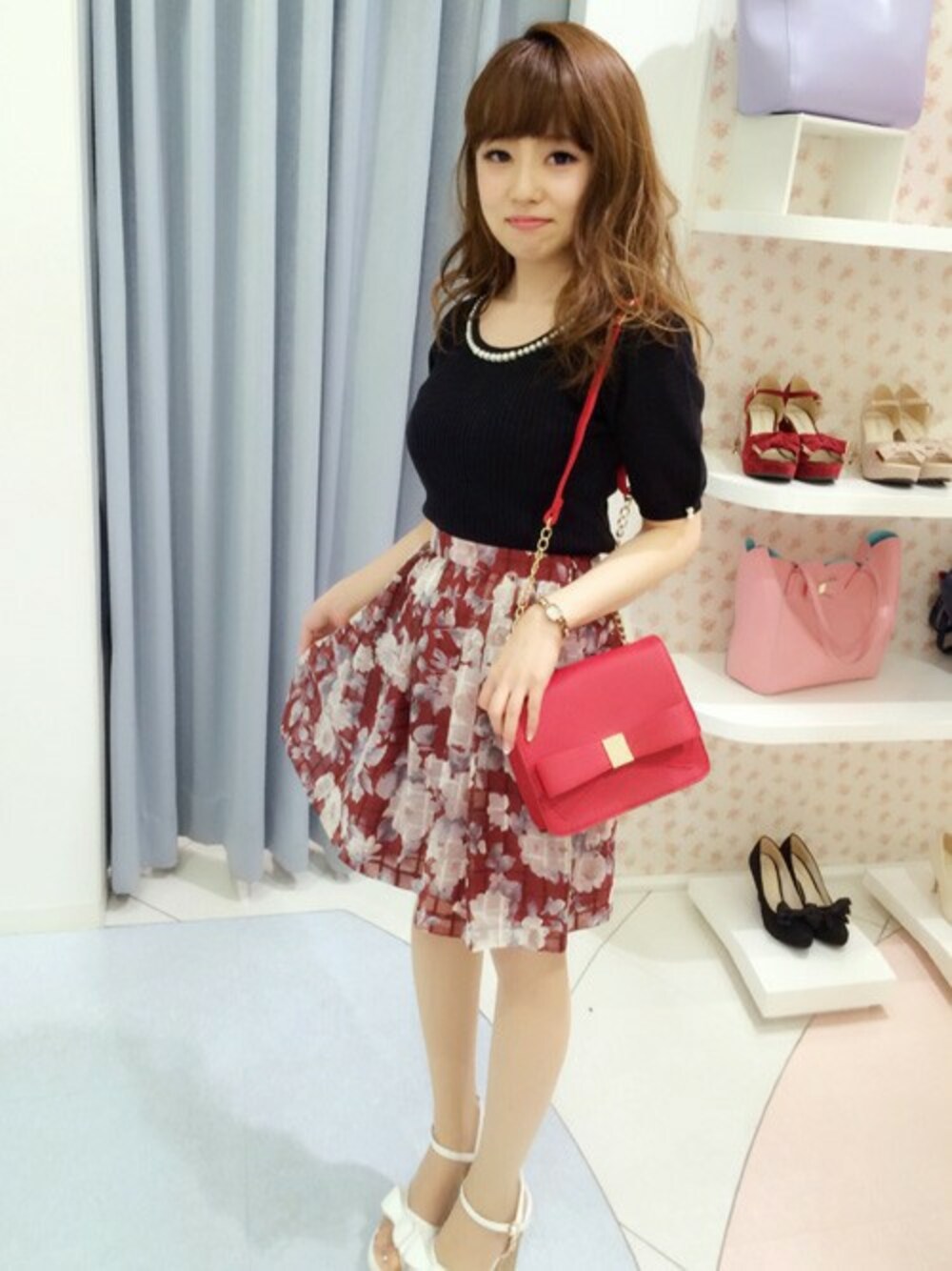 ホワイト系のサンダル、レッド系のショルダーバッグ、レッド系のスカートを着用したレディースの夏コーディネートの1枚目の写真