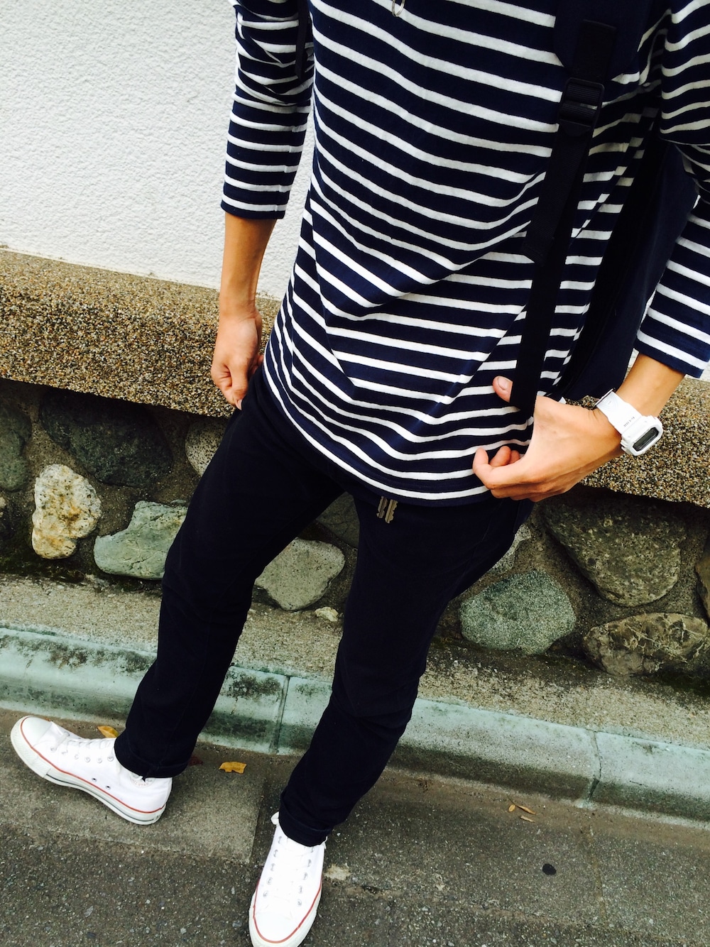 ホワイト系のスニーカー、ブラック系のデニムパンツ、ブルー系のTシャツ/カットソーを着用したメンズの秋コーディネートの1枚目の写真