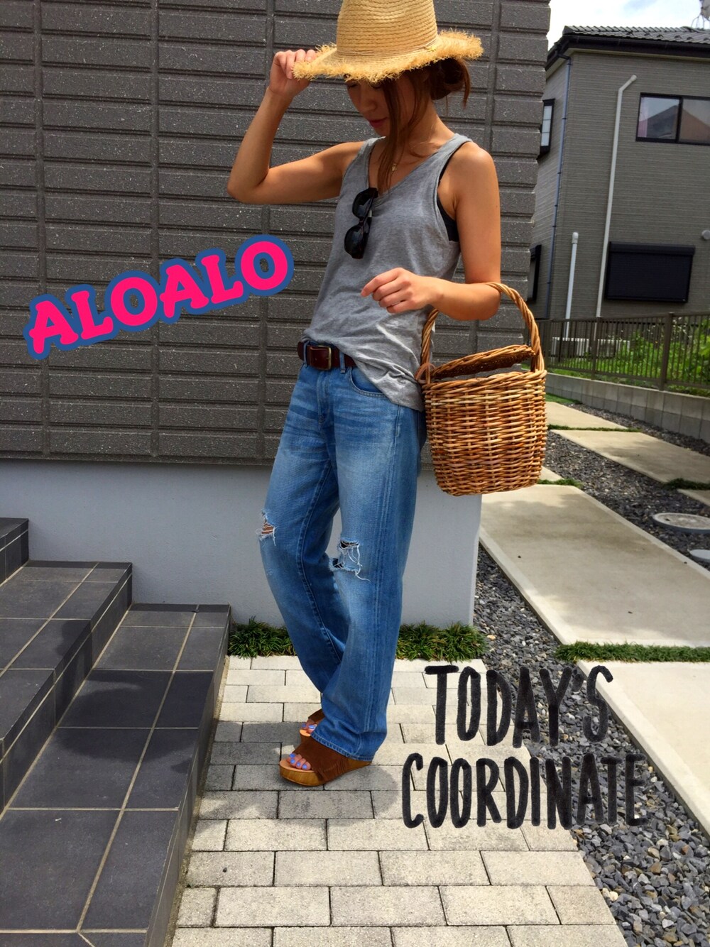 ブルー系のデニムパンツ、ブラウン系のサンダルを着用したレディースの夏コーディネートの1枚目の写真