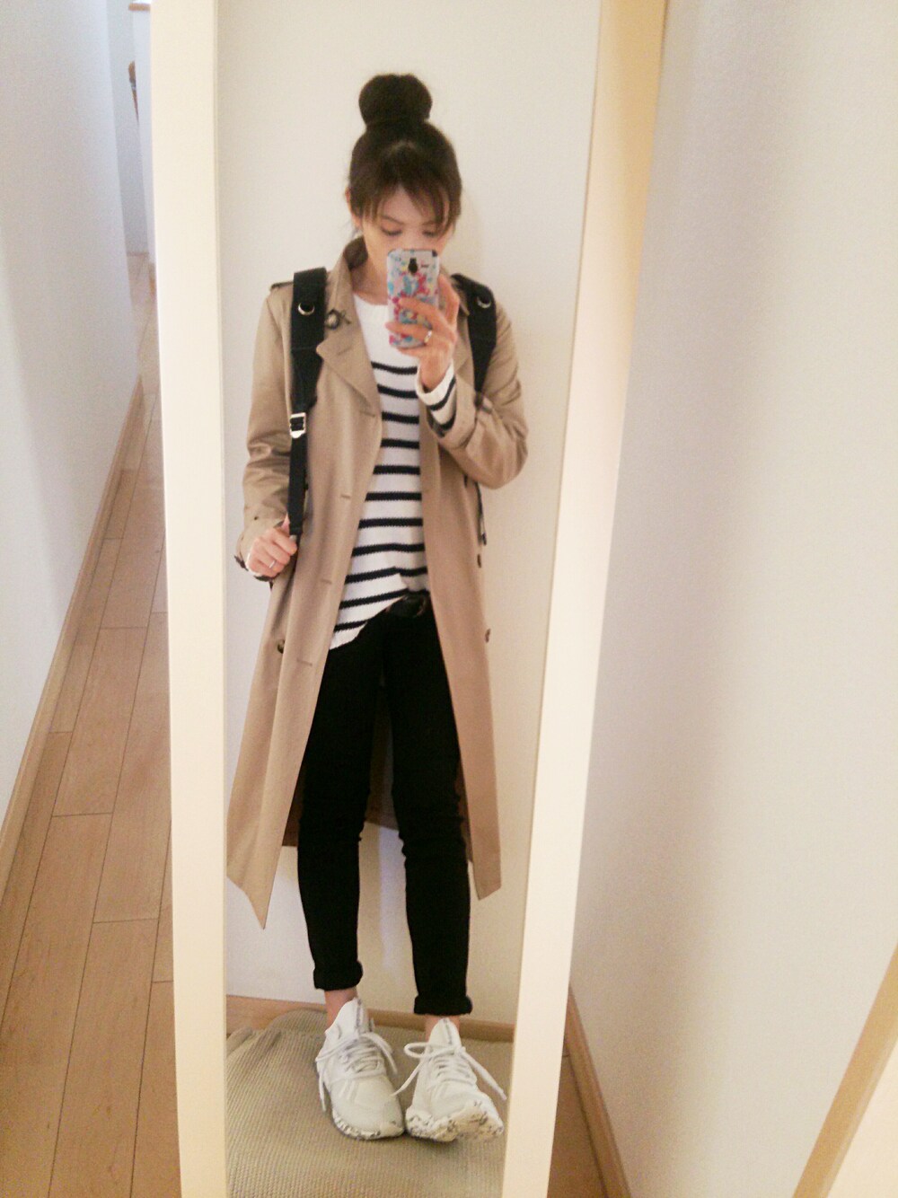 ホワイト系のスニーカー、ホワイト系のトップス、ブラック系のバックパック/リュックを着用したレディースの冬コーディネートの1枚目の写真