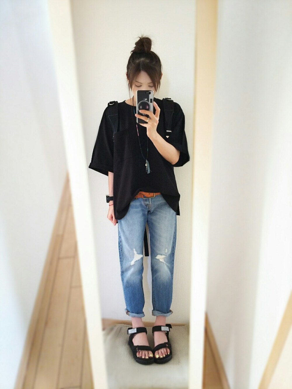 ブラック系のTシャツ/カットソー、ブルー系のデニムパンツ、ブラック系のサンダルを着用したレディースの夏コーディネートの1枚目の写真