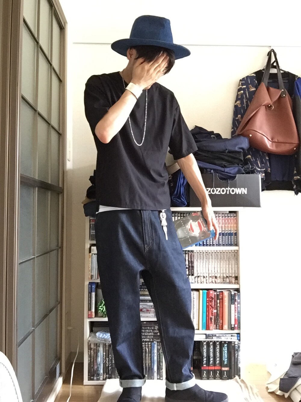 ブラック系のTシャツ/カットソー、ブルー系のデニムパンツ、ブラック系のスニーカーを着用したメンズの夏コーディネートの1枚目の写真