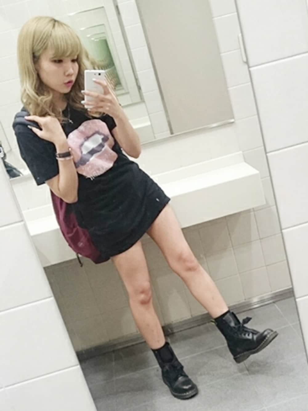 ブラック系のTシャツ/カットソー、レッド系のバックパック/リュック、ブラック系のブーツを着用したレディースの春コーディネートの1枚目の写真