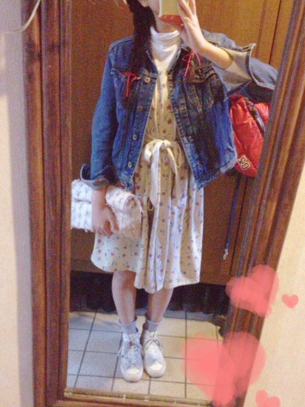 ピンク系のクラッチバッグ、ベージュ系のワンピース、ブルー系のデニムジャケットを着用したレディースの春コーディネートの1枚目の写真