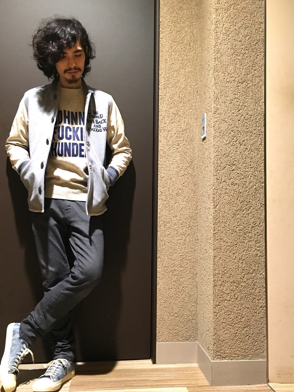 グレー系のスタジャン、ベージュ系のニット/セーター、グレー系のその他パンツを着用したメンズの秋コーディネートの1枚目の写真