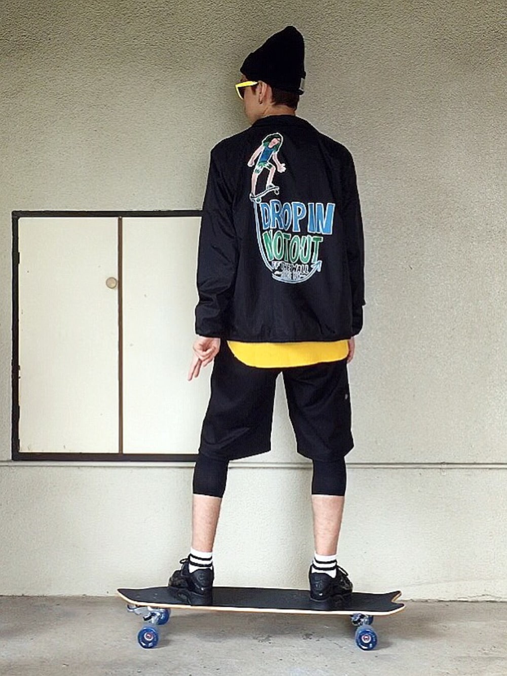 ブラック系のナイロンジャケット、イエロー系のTシャツ/カットソー、ブラック系のその他パンツを着用したメンズの秋コーディネートの1枚目の写真