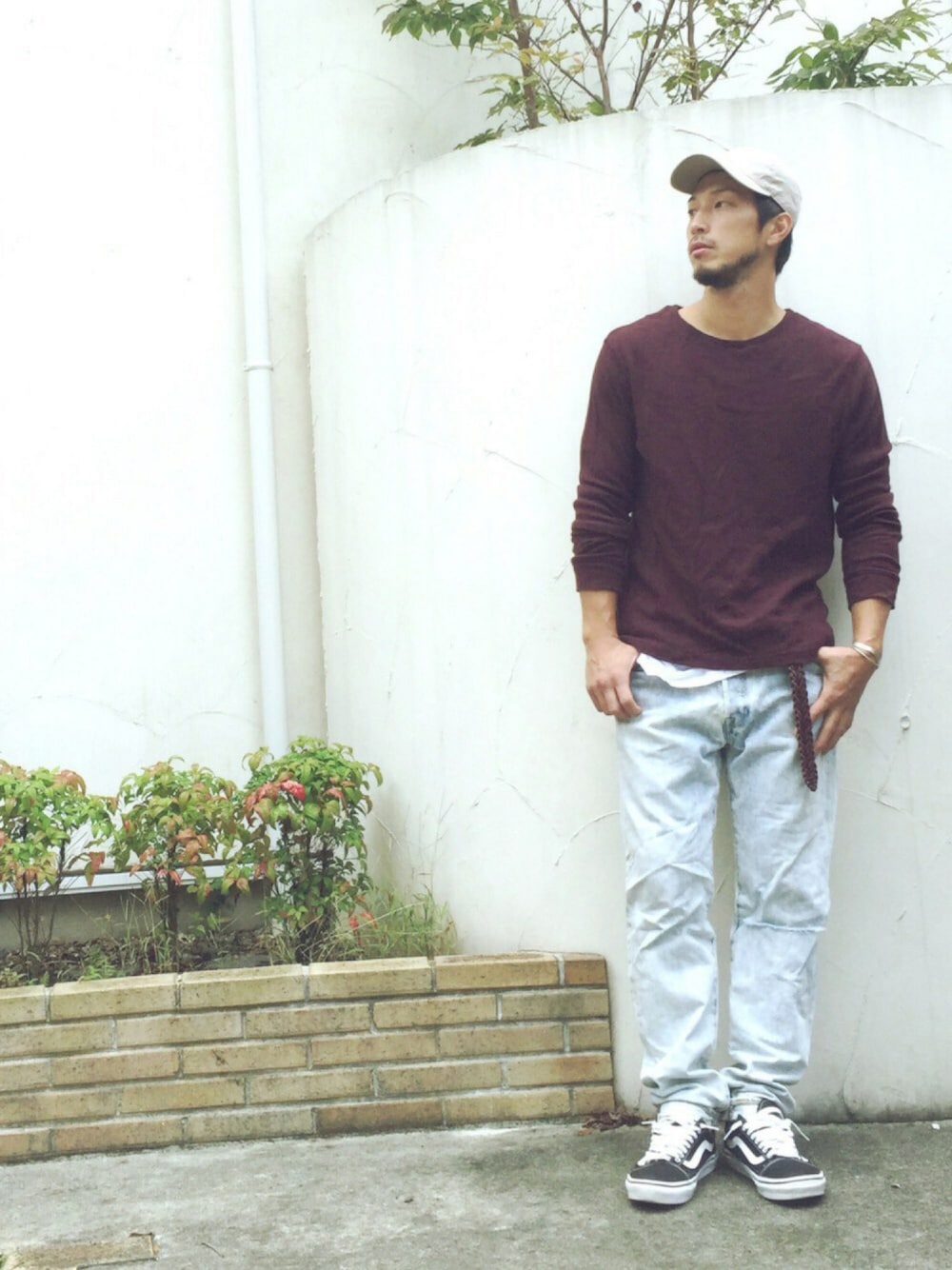 パープル系のTシャツ/カットソー、ブルー系のデニムパンツ、ブラック系のスニーカーを着用したメンズの秋コーディネートの1枚目の写真