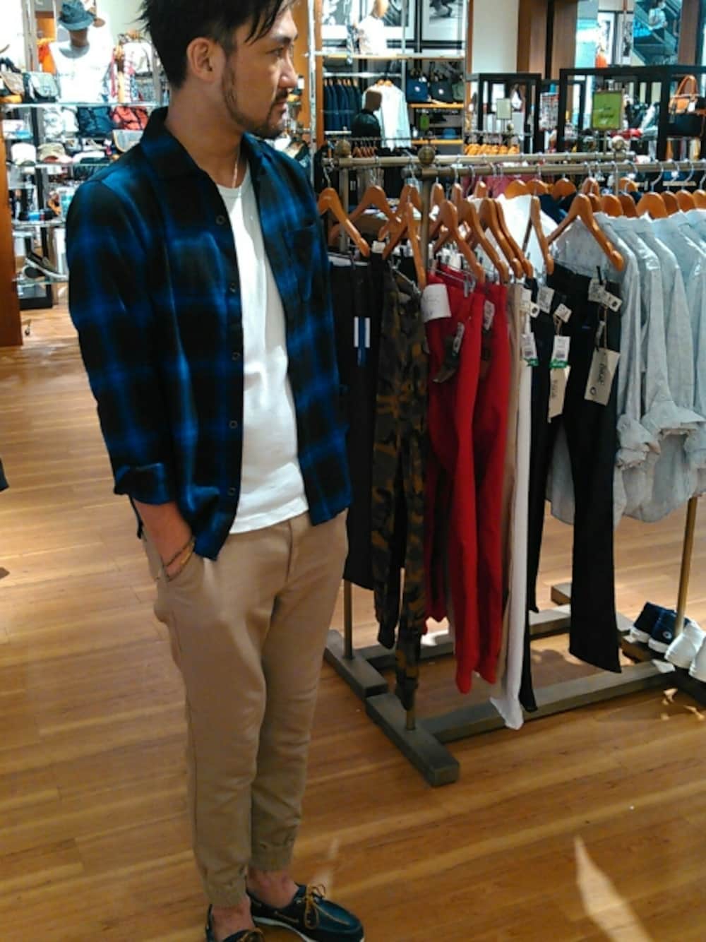 ブルー系のシャツ/ブラウス、ホワイト系のTシャツ/カットソー、ベージュ系のパンツを着用したメンズの秋コーディネートの1枚目の写真