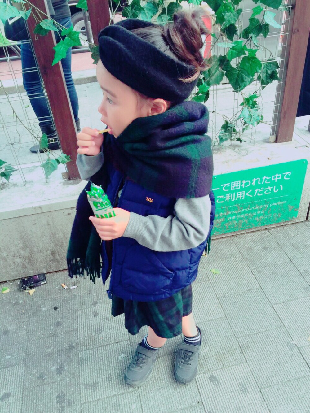 ブルー系のダウンベスト、グリーン系のスカート、グレー系のニット/セーターを着用したキッズの秋コーディネートの1枚目の写真