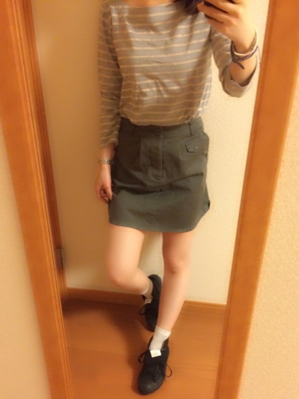 グレー系のTシャツ/カットソー、ブラック系のスニーカー、ブラウン系のバングル/リストバンドを着用したレディースの秋コーディネートの1枚目の写真