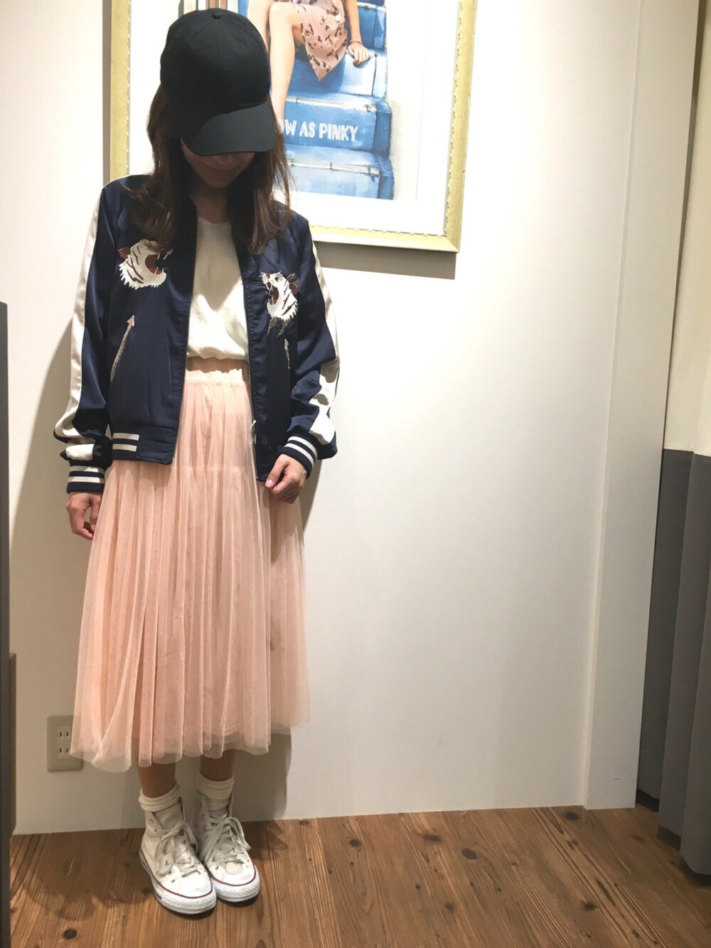 ピンク系のスカート、ブルー系のスタジャン、ホワイト系のトップスを着用したレディースの春コーディネートの1枚目の写真