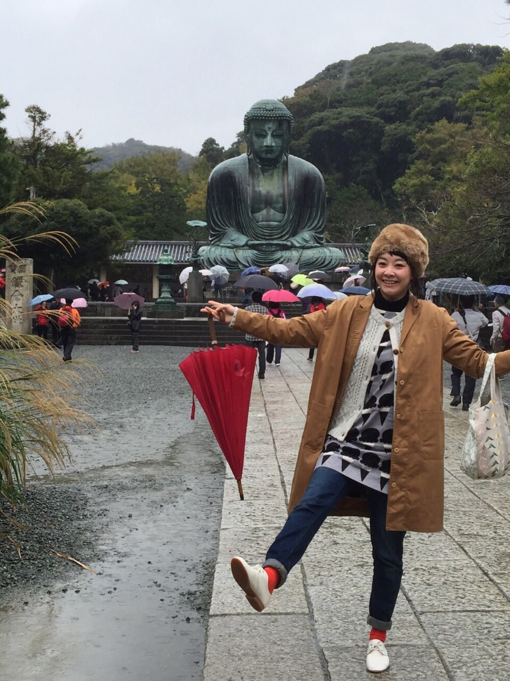 グレー系のワンピース、ブラウン系のトレンチコート、その他のバッグを着用したレディースの秋コーディネートの1枚目の写真