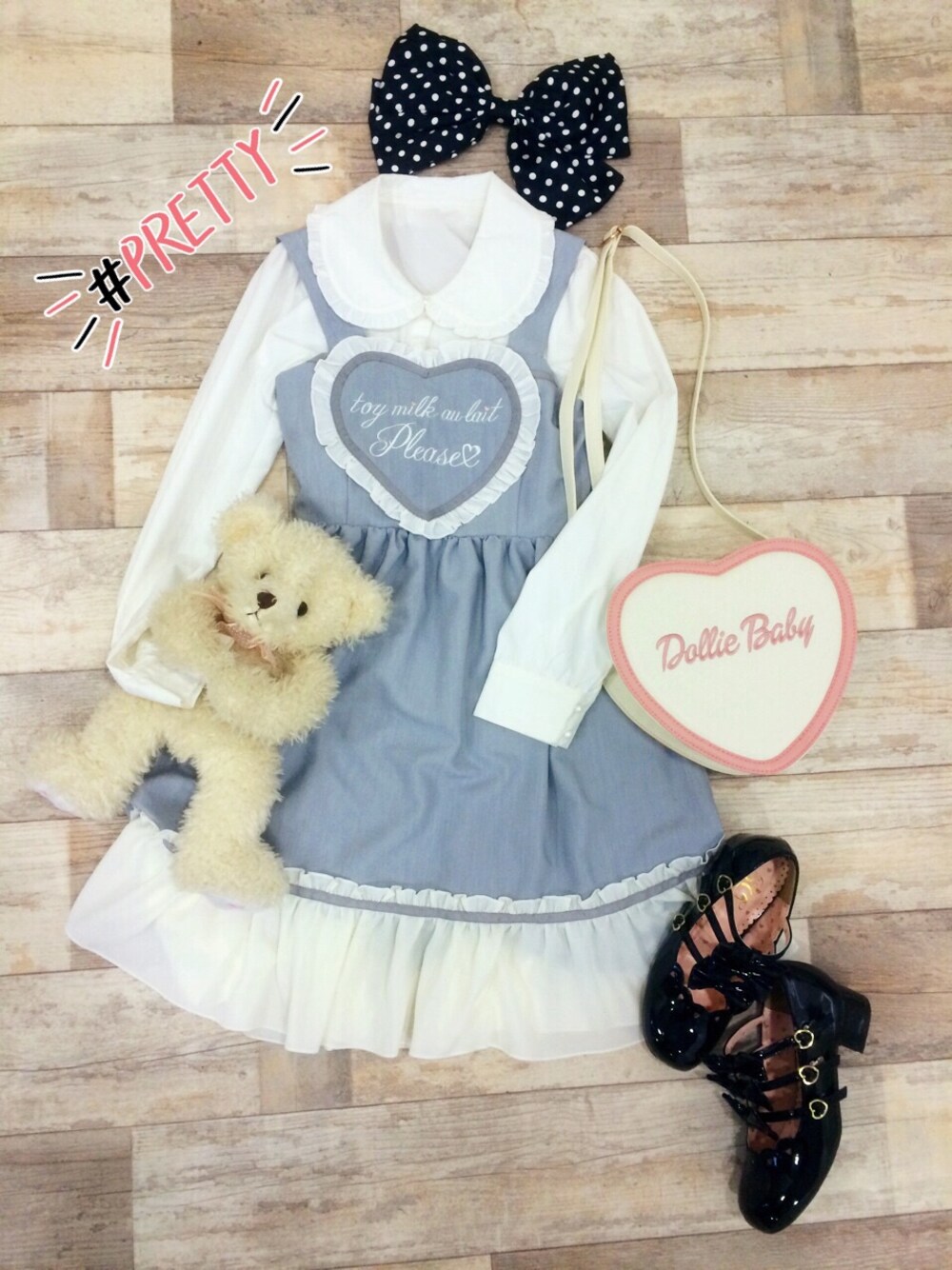 グレー系のワンピース/ドレス、ホワイト系のトップス、ブラック系のパンプスを着用したレディースの冬コーディネートの1枚目の写真