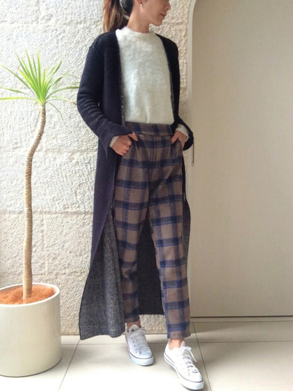 ホワイト系のスニーカー、ブラウン系のその他パンツ、ブルー系のカーディガン/ボレロを着用したレディースの冬コーディネートの1枚目の写真