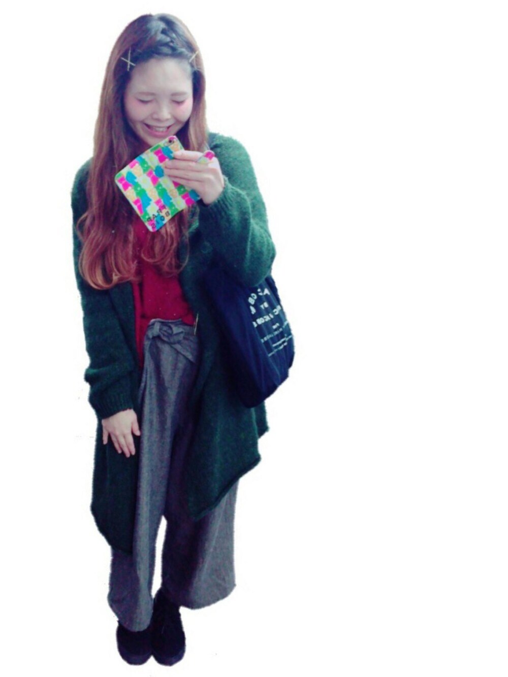 グリーン系のカーディガン/ボレロ、レッド系のニット/セーター、ブラック系のトートバッグを着用したレディースの冬コーディネートの1枚目の写真